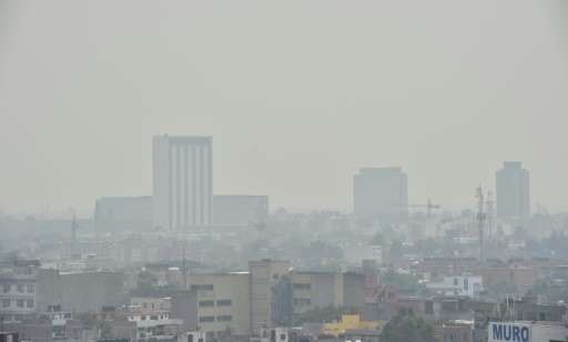 Partial view of Mexico City covered in smog on May 3, 2016