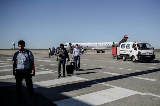 Passengers disembark from a South African Express flight at George airport