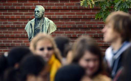 People crowd in front of a statue of Swedish inventor Alfred Nobel at the Karolinska Institute in Stockholm