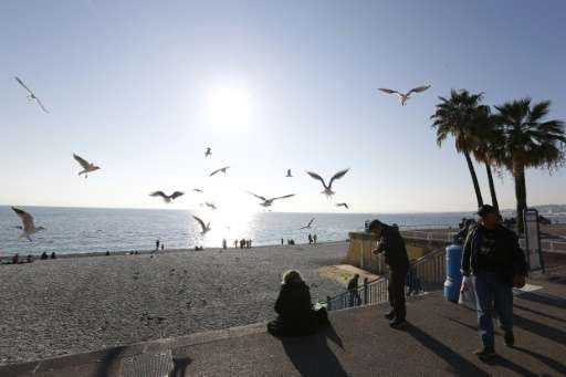 People enjoy the sun and warm temperatures on the &quot;Promenade des Anglais&quot; in Nice, southeastern France, on December 28