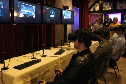 People try out a &quot;Star Trek&quot; themed Ubisoft virtual reality game on June 12, 2016