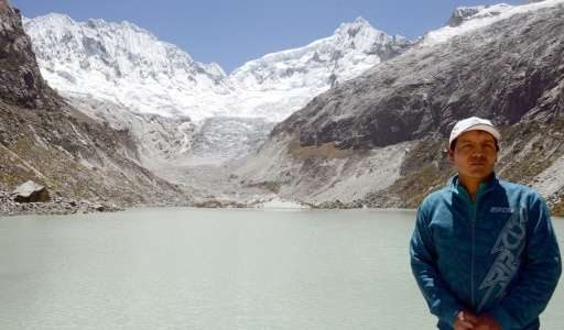 Peruvian mountan guide Saul Luciano Lliuya, stands in front of a lagoon that has formed at the base of the almost disappeared Ch