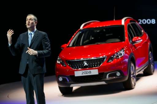 Peugeot Brand CEO Maxime Picat gestures while speaking in front of the new SUV Peugeot 2008, at the Geneva Motor Show on March 1