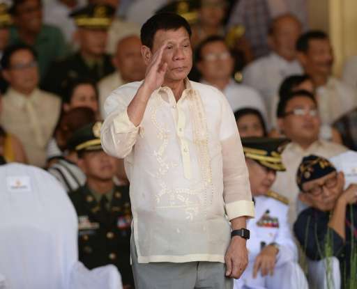 Philippines President Rodrigo Duterte salutes during a military parade and change of command ceremony, at the military headquart