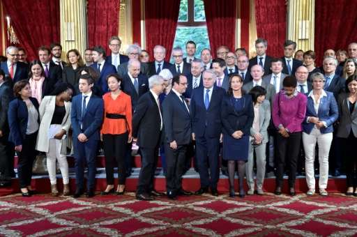 President Francois Hollande (centre) and his cabinet pose for a group photo after France became the first country to ratify the 