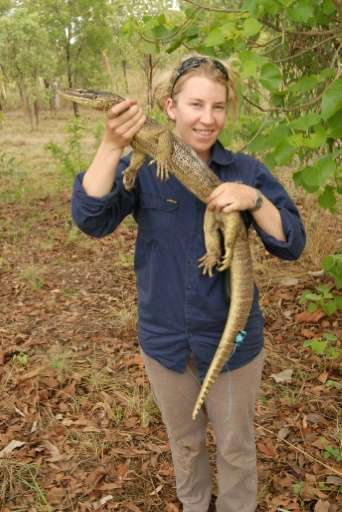 Researcher Georgia Ward-Fear holds a floodplain monitor lizard in the Kimberly region of Western Australia