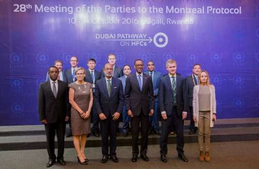 Rwandan President Paul Kagame (3rd R) poses with participants during the official opening of the 28th meeting of the Parties to 