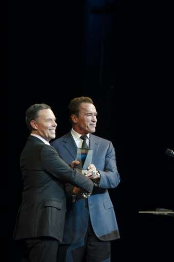 Simon Bransfield-Garth (right) receives a sustainability award from Arnold Schwarzenegger in Copenhagen