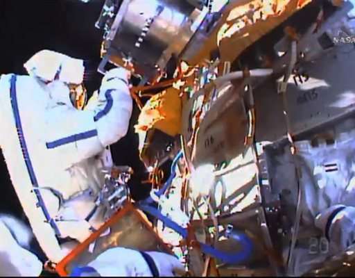 Spacewalkers collect experiments, toss flash drive overboard