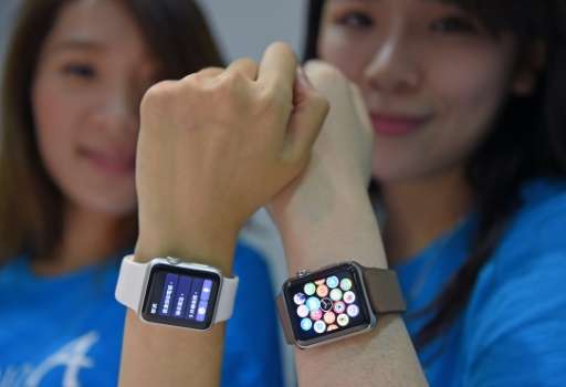 Staff at an Apple store display the company's new Apple Watch as it goes on sale in Taipei