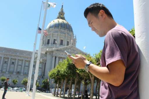 Steven Kong plays Pokemon Go in front of San Francisco City Hall on July 12, 2016