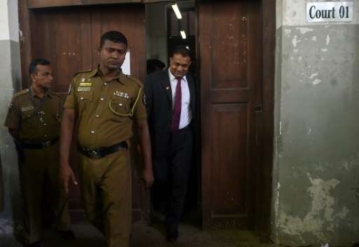 Suspended Sri Lankan judge Thilina Gamage (R) walks out of the High Court in Colombo on June 21, 2016, after being granted bail 