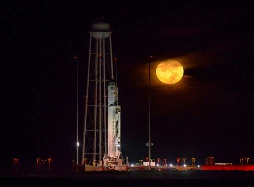 The Antares rocket emblazoned with an American flag lit up the night sky as it blasted off from Wallops Island, Virginia