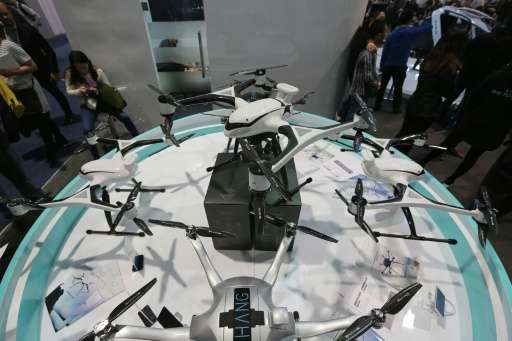 The EHang commercial drones Series V.1 and Series V.2 (top C) are displayed at the Consumer Electronics Show in Las Vegas, Nevad
