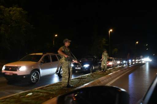 Turkish security officers stand on guard on the side of the road on July 15, 2016 in Istanbul, during a shutdown of the Bosphoru