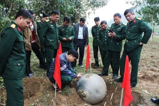 Vietnamese soldiers inspect a metal ball which landed in the northern province of Tuyen Quang
