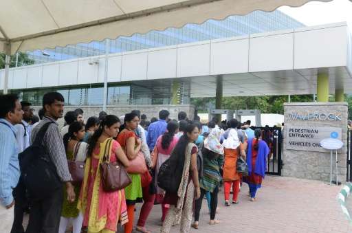 Visitors to the new Apple development office line up in Hyderabad on May 19, 2016