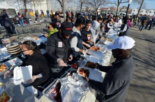 Volunteers serve Thanksgiving dinner to residents in the Rockaways section of Queens  in New York, as the city recovers from Sup