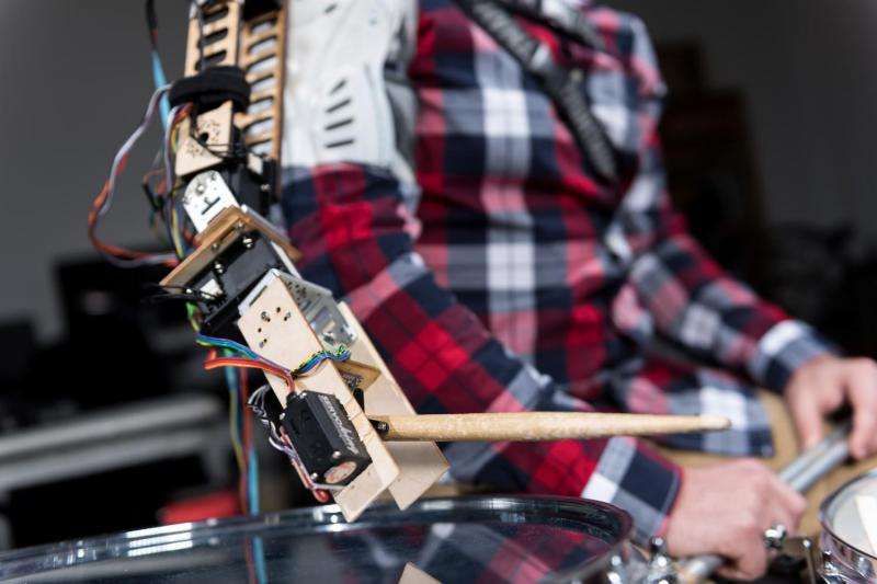 Wearable robot transforms musicians into 3-armed drummers