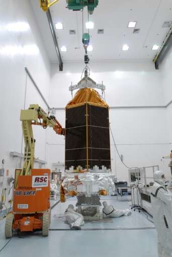 Workers check the Kepler space telescope at the Hazardous Processing Facility at Astrotech in Titusville, Florida, on February 1