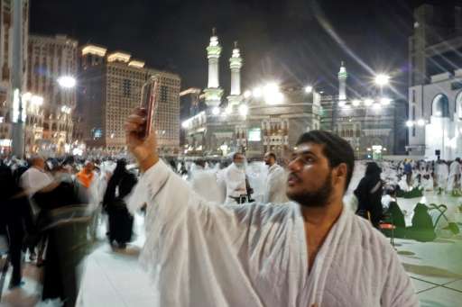 A Muslim pilgrim takes a selfie at the Grand Mosque in the holy Saudi city of Mecca, early on August 30, 2017, on the eve of the