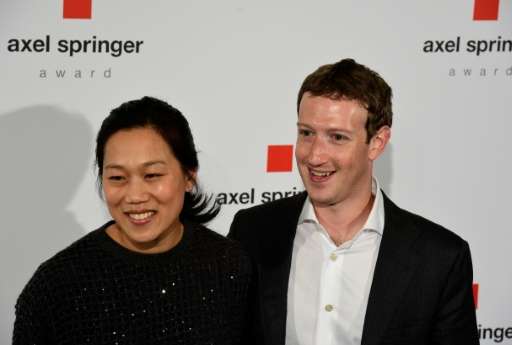Facebook founder and CEO Mark Zuckerberg, seen in 2016 with his wife Priscilla Chan, says he can fund the couple's philanthropy 