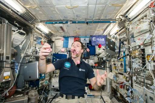 French astronaut Thomas Pesquet displays his juggling and eating skills  during a light moment on the International Space Statio