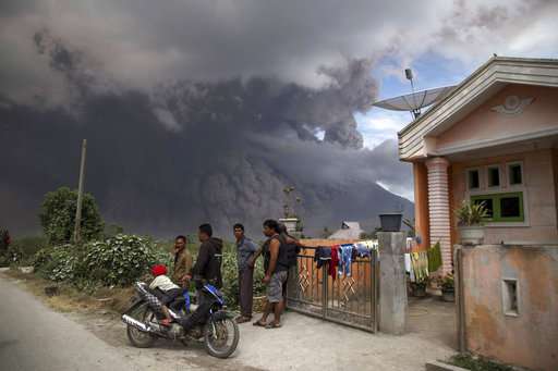 New eruption at Indonesia volcano spreads ash for miles