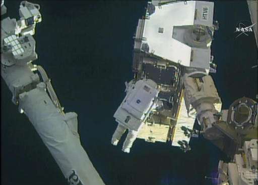 Spacewalking astronauts upgrade station with new batteries