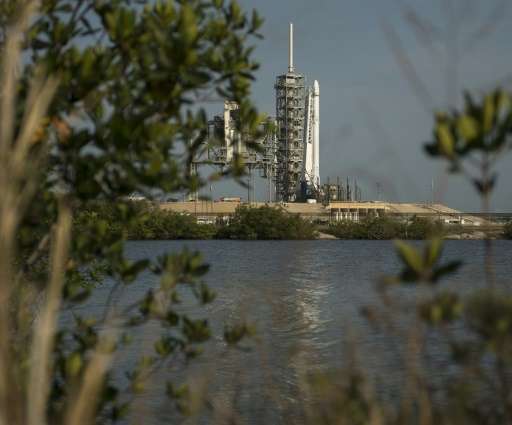 This image released by NASA shows the SpaceX Falcon 9 rocket, with the Dragon spacecraft onboard, shortly after being raised ver