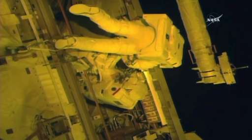 This NASA TV video grab shows astronauts Jack Fischer(top) and Peggy Whitson(below) as they make repairs outside the Internation