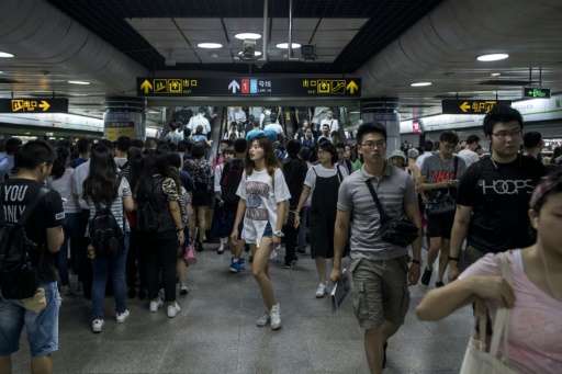 This picture taken on July 19 shows commuters during the morning rush hour at a station of the Shanghai Metro in Shanghai