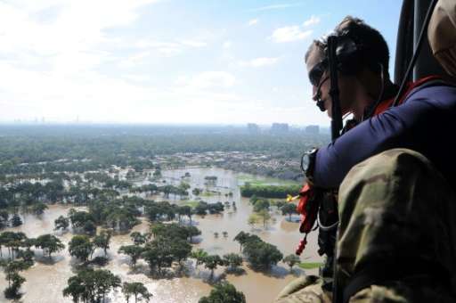 A member of the US Air National Guard surveys flood damage in Houston