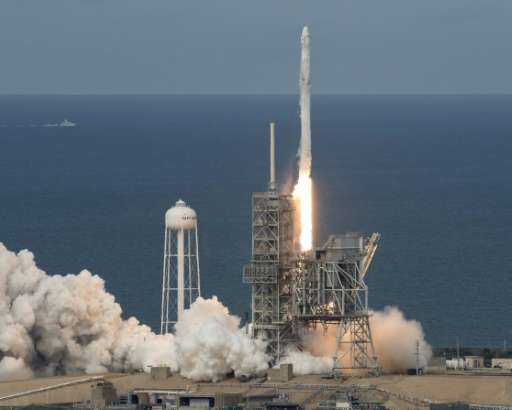A SpaceX Falcon 9 rocket, with the Dragon spacecraft onboard, launches from NASA's Kennedy Space Center in Cape Canaveral, Flori