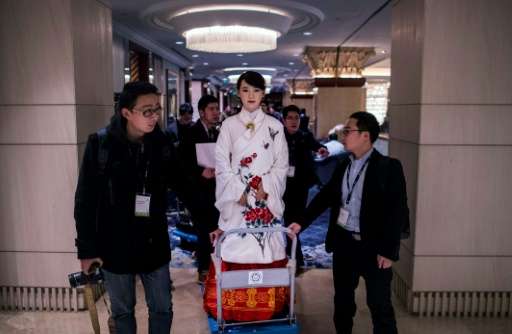 The humanoid robot 'Jia Jia' is carried by workers following a presentation at a conference in Shanghai, on January 9, 2017