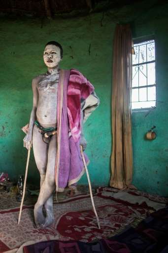 This file photo taken on July 11 shows traditional Xhosa initiate Fezikhaya Tselane, 20 years old, standing during a traditional