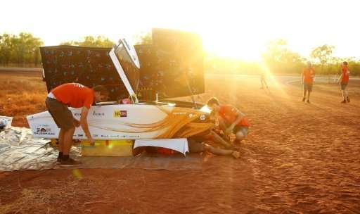 This handout from the World Solar Challenge 2017 shows team members of Nuon Solar Team from the Netherlands preparing their vehi