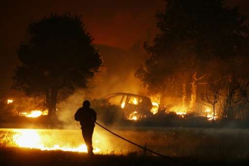 A firefighter battles a blaze in Biguglia, on the French Mediterranean island of Corsica