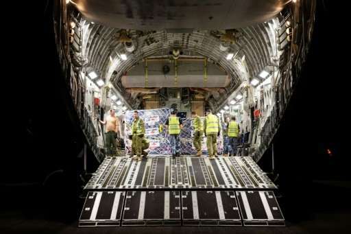 A handout photo shows Royal Australian Air Force personnel preparing to unload Australian Aid supplies from a C-17 Globemaster o
