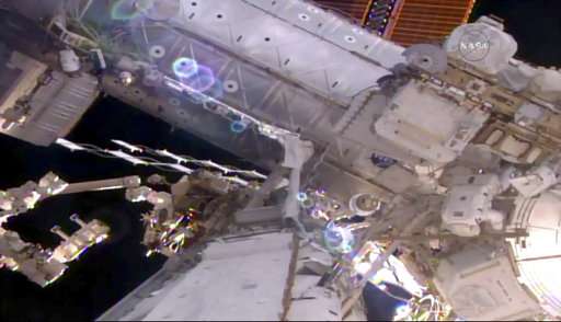 Spacewalking astronauts prep station for new parking spot