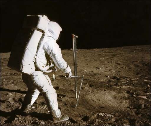 Astronaut Buzz Aldrin conducts an experiment on the moon's surface in this photo taken by his colleague Neil Armstrong, the firs