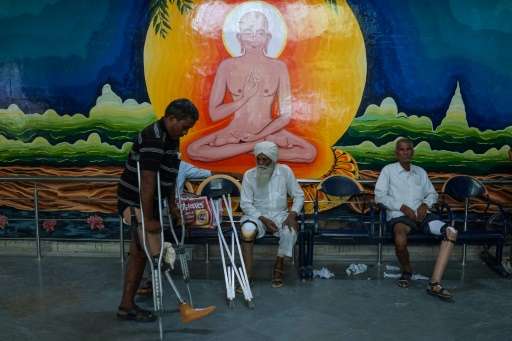 In this photograph taken on June 13, 2017, an Indian man practices walking with a rubber-based prosthetic leg at the Bhagwan Mah