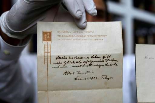 A picture taken on October 19, 2017 shows one of two notes written by Albert Einstein, in 1922, on stationary from the Imperial 
