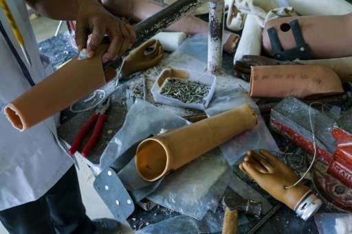 In this photograph taken on June 13, 2017, workers make rubber-based prosthetic legs and hands at the Bhagwan Mahaveer Viklang S