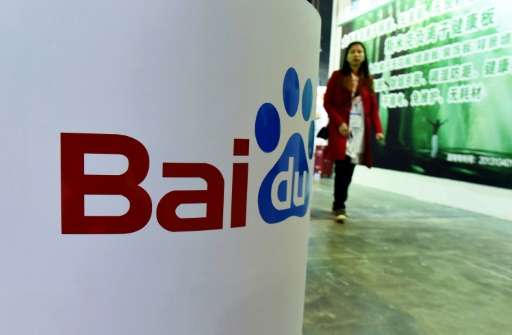 This photo taken on April 21, 2016 shows a woman walking past the Baidu booth at the China (ShangHai) International Technology F