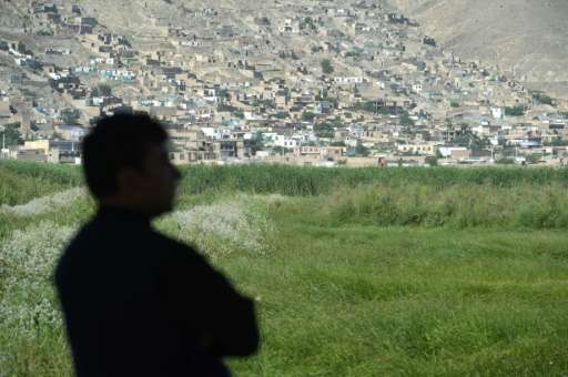 A birdwatcher looks on at the Kol-e Hashmat Khan wetland in the outskirts of Kabul