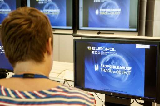 A Europol police agent looks at the onscreen logo of a new website launched by Europol at the Europol headquarters in The Hague 