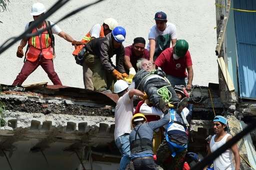 A man being pulled alive from the rubble following the powerful quake that struck Mexico City on Tuesday