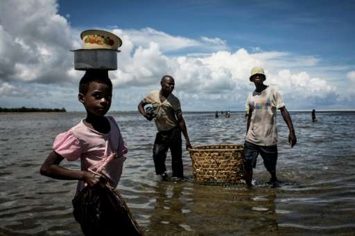A Mozambican girl arriving to buy fish in Palma, where large deposits of natural gas where found offshore