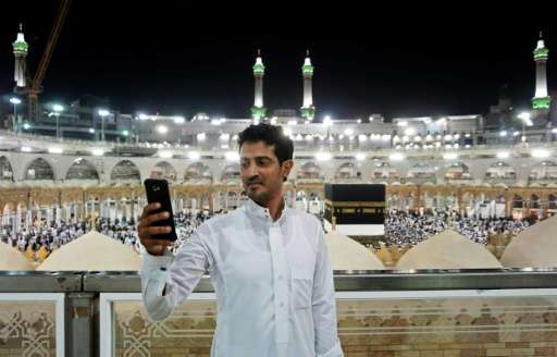 A Muslim pilgrim takes a selfie at the Grand Mosque in the holy Saudi city of Mecca, early on August 30, 2017, on the eve of the